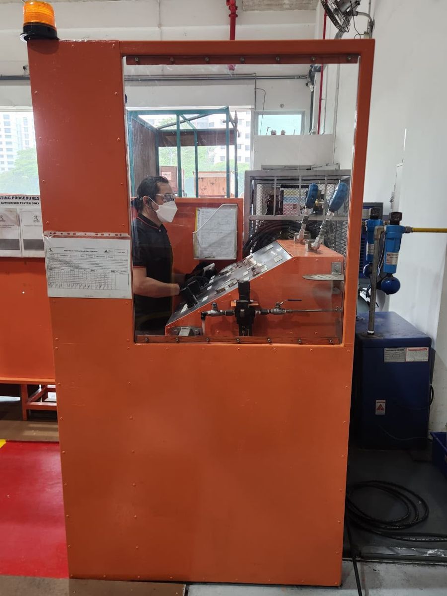 Technician at the enclosed pressure test booth
