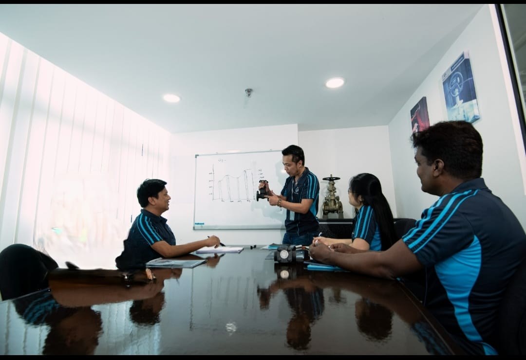 Imperial Royal team reviewing a valve in our Singapore office meeting room